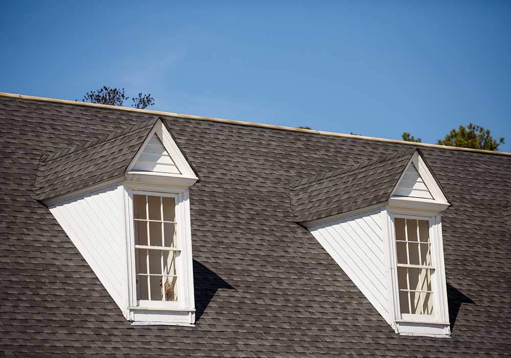 Two-White-Dormers-on-Gray-Shingle-Roof
