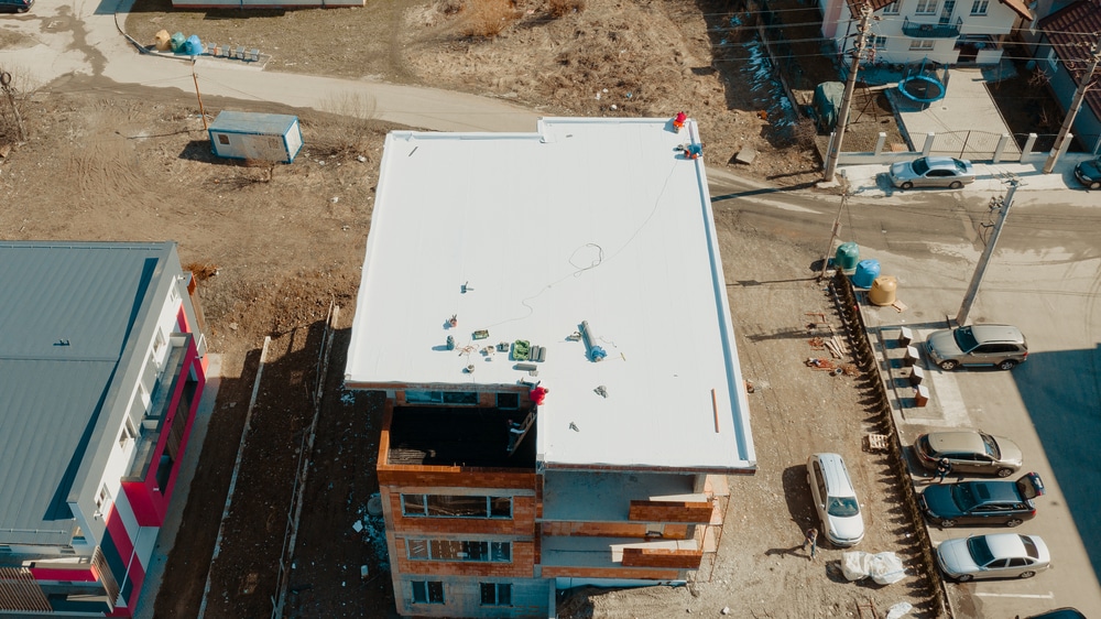 aerial view of apartment building with flat epdm roof in construction